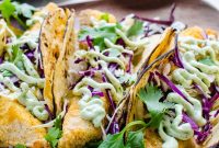 Crispy Baked Fish Tacos with Lime Slaw and Avocado crema