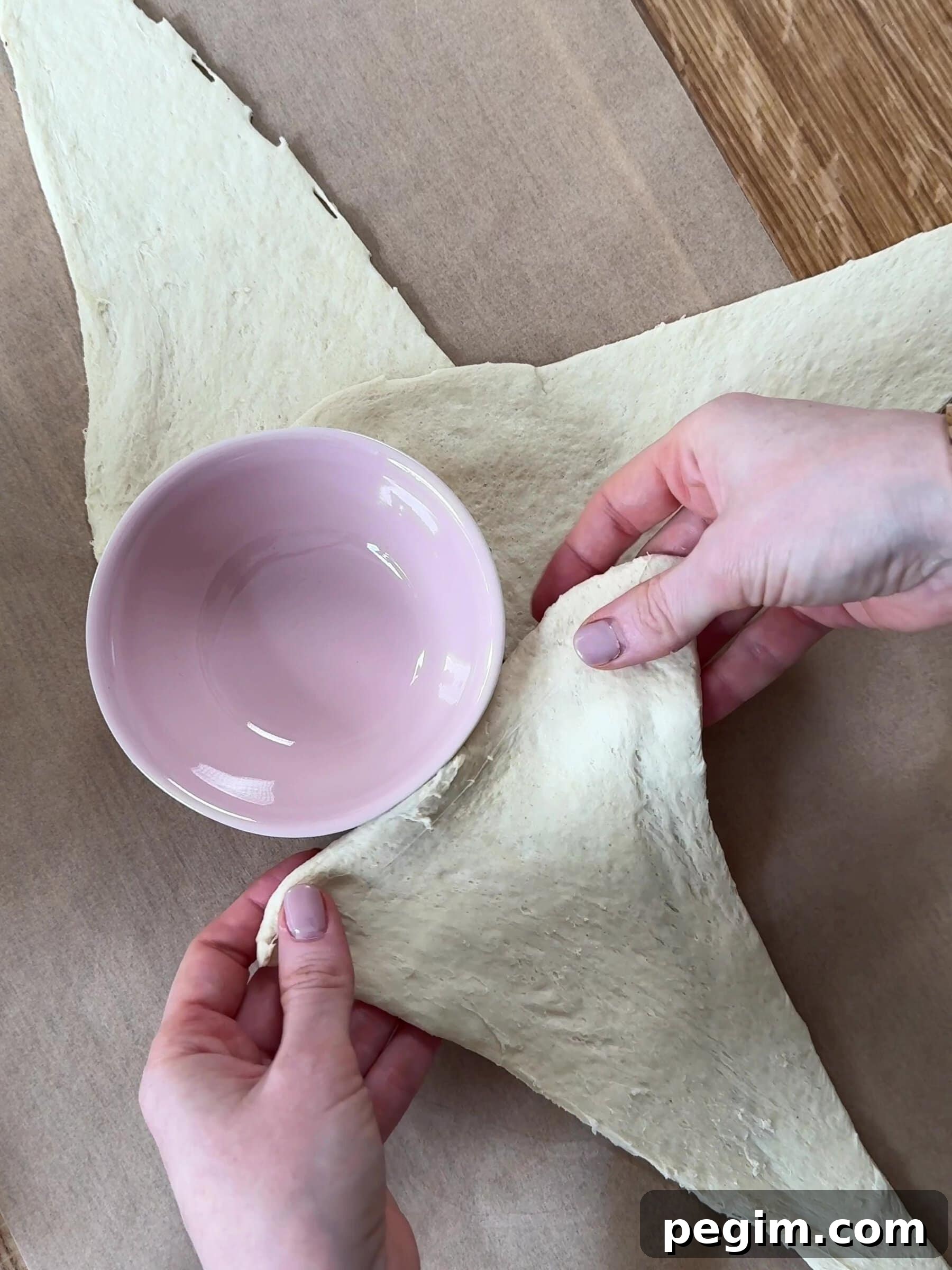 Placing croissant dough around the ramekin