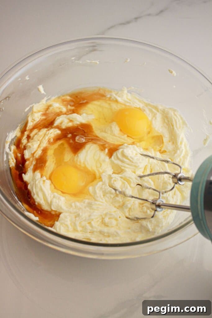 Eggs, vanilla, and butter in a glass mixing bowl.
