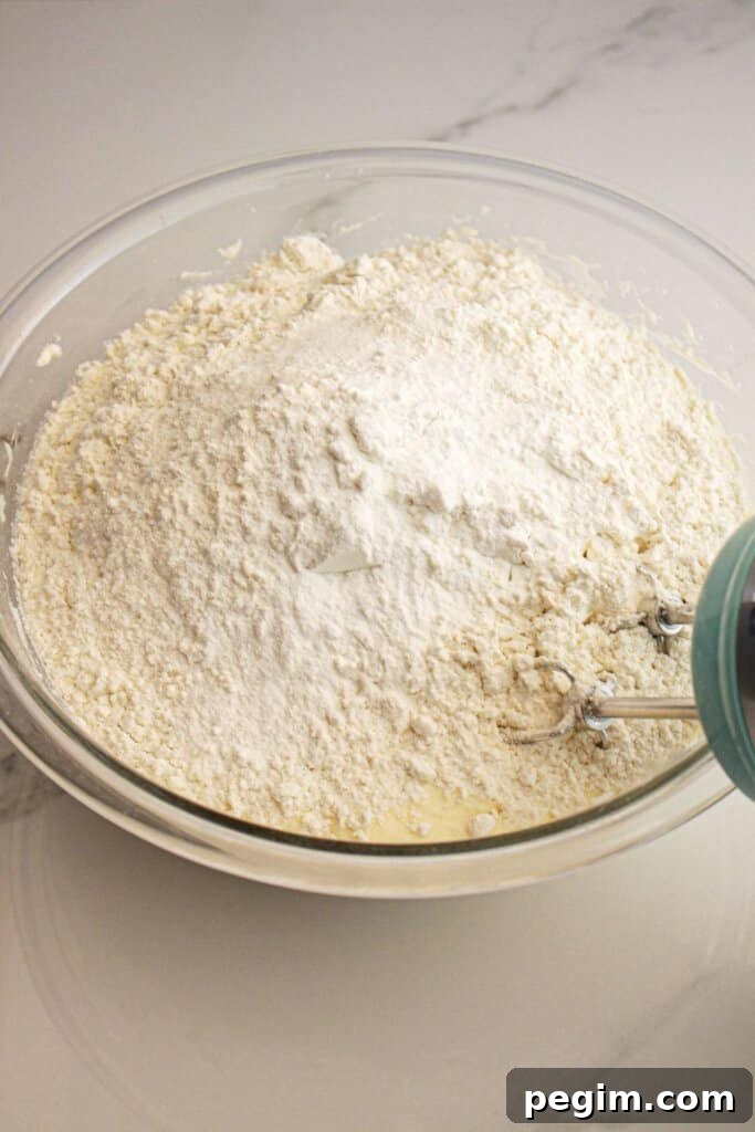 Dry ingredients being added to wet ingredients.