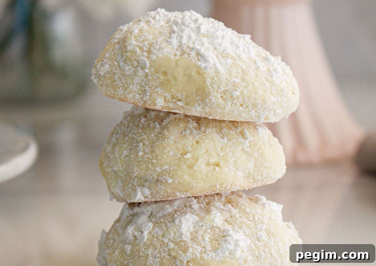 Three cream cheese cookies stacked on top of each other.