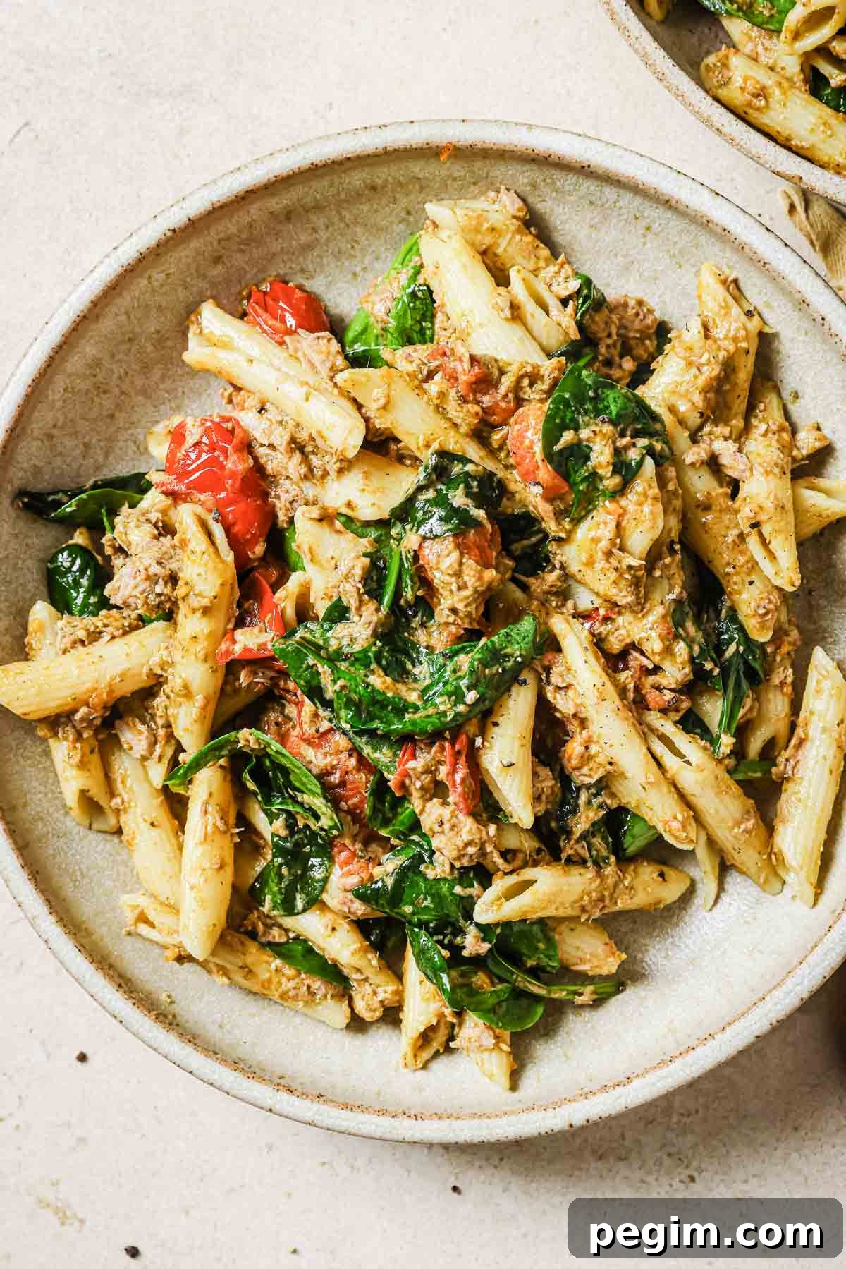 Two bowls of tuna pesto pasta.
