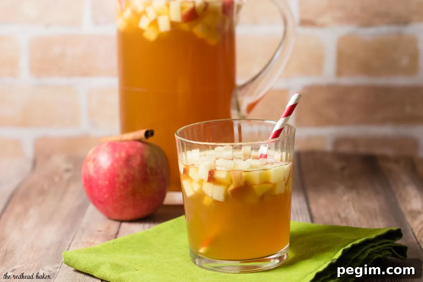 Cinnamon apple cider sangria is a delicious fall cocktail combining white wine, apple cider, apple brandy and cinnamon whiskey. #AppleWeek