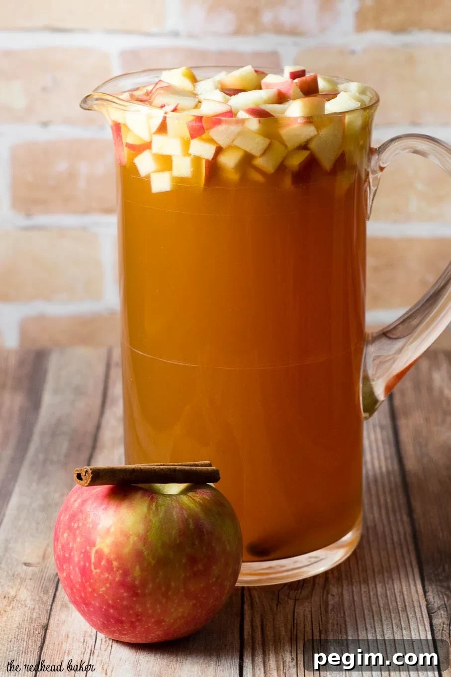 Cinnamon apple cider sangria is a delicious fall cocktail combining white wine, apple cider, apple brandy and cinnamon whiskey. #AppleWeek