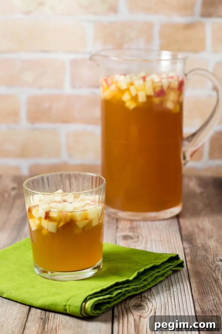 Cinnamon apple cider sangria is a delicious fall cocktail combining white wine, apple cider, apple brandy and cinnamon whiskey. #AppleWeek