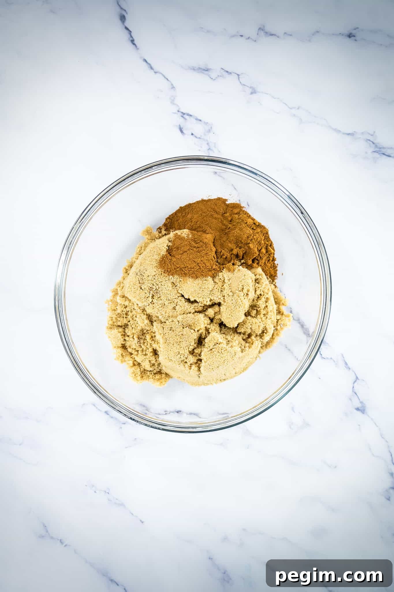 Ground cinnamon and brown sugar in a glass bowl