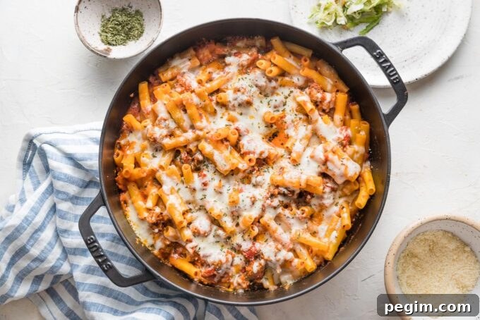 Baked ziti just baked in a skillet with melted mozzarella on top.