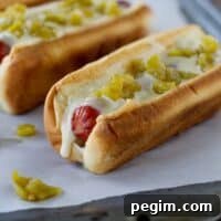 Green Chile Hot Dogs with a green chile sauce and diced green chiles.