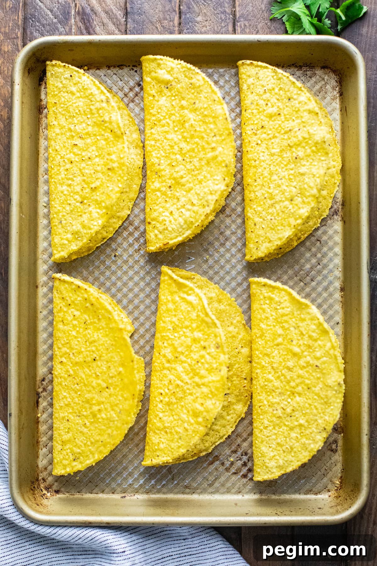 hardshell tortillas on a baking sheet pan.