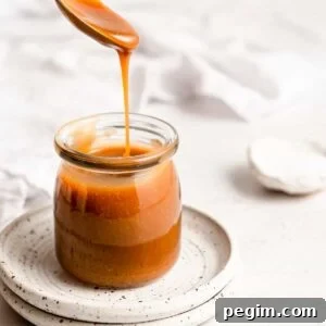 Homemade caramel sauce in a glass jar.