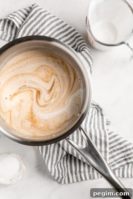 Brown sugar and coconut milk cooking in a saucepan.