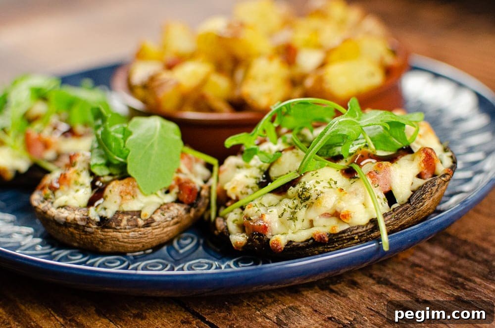 Pancetta mushrooms with mozzarella on a blue plate served with rocket salad and potato squares