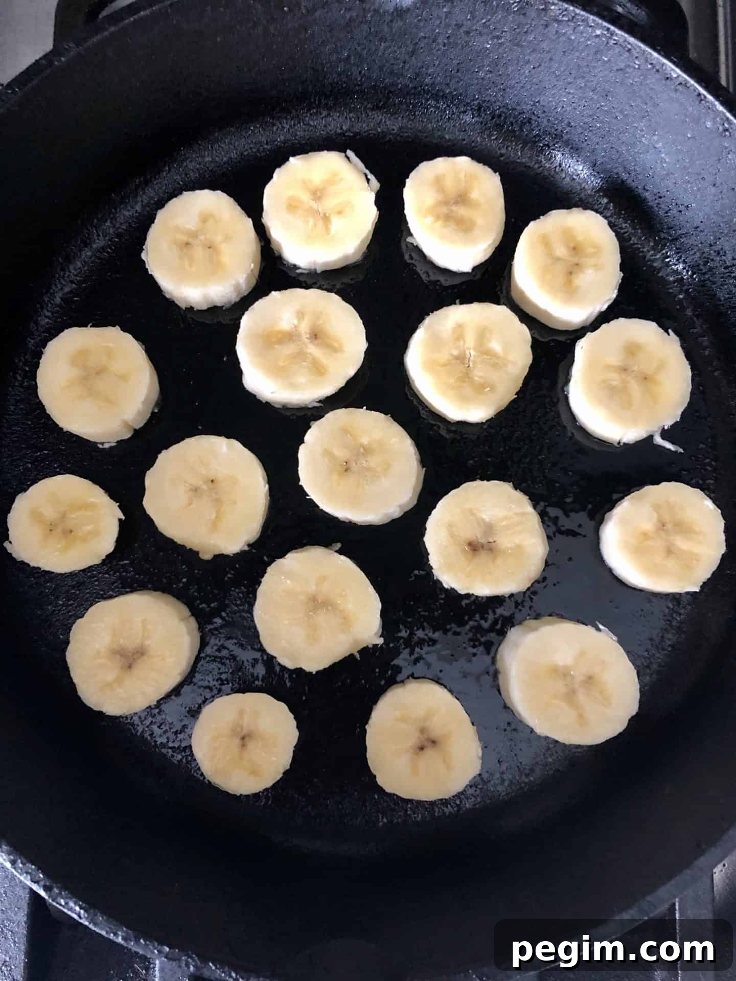 Cast iron pan with bananas being cooked overhead shot