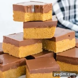 close up shot of No-Bake Peanut Butter Bars stacked on top of each other