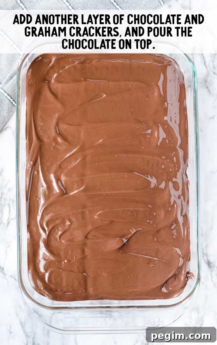 graham crackers and chocolate mixture spread over the peanut butter