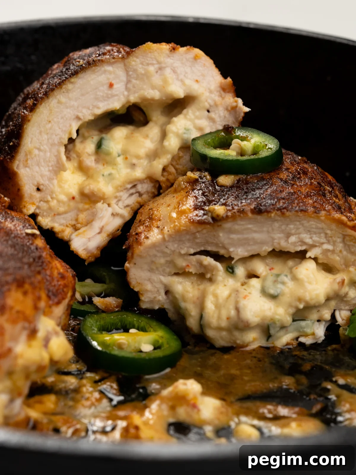 Half cut jalapeno popper stuffed chicken breast served with green salad
