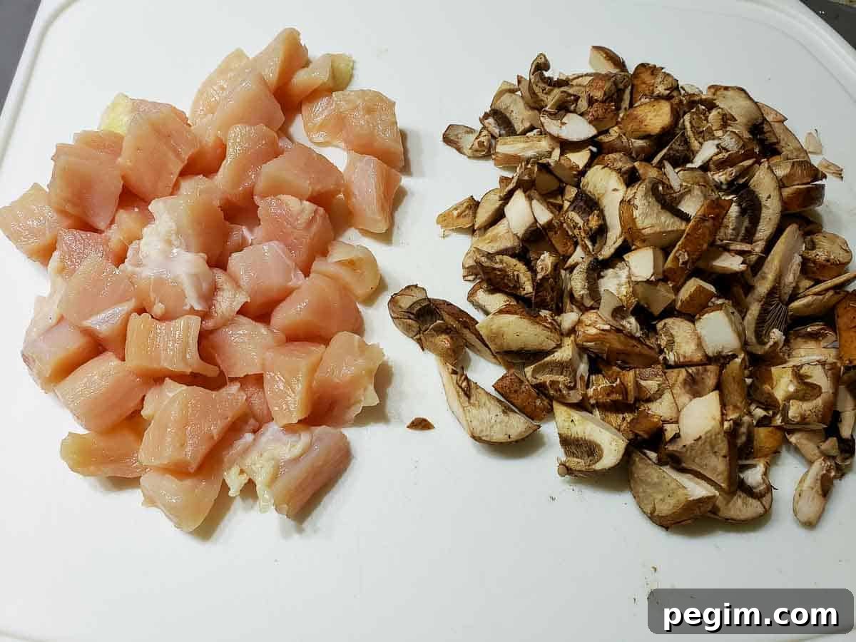 diced chicken and mushrooms on a cutting board