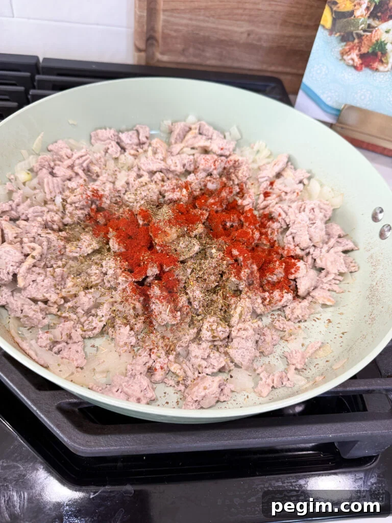 season ground turkey in pan