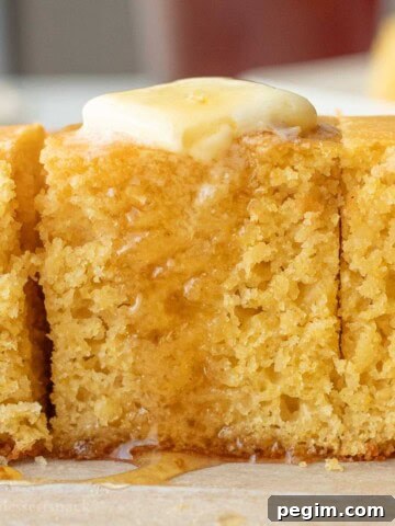 Drizzling honey over buttered cornbread slices.