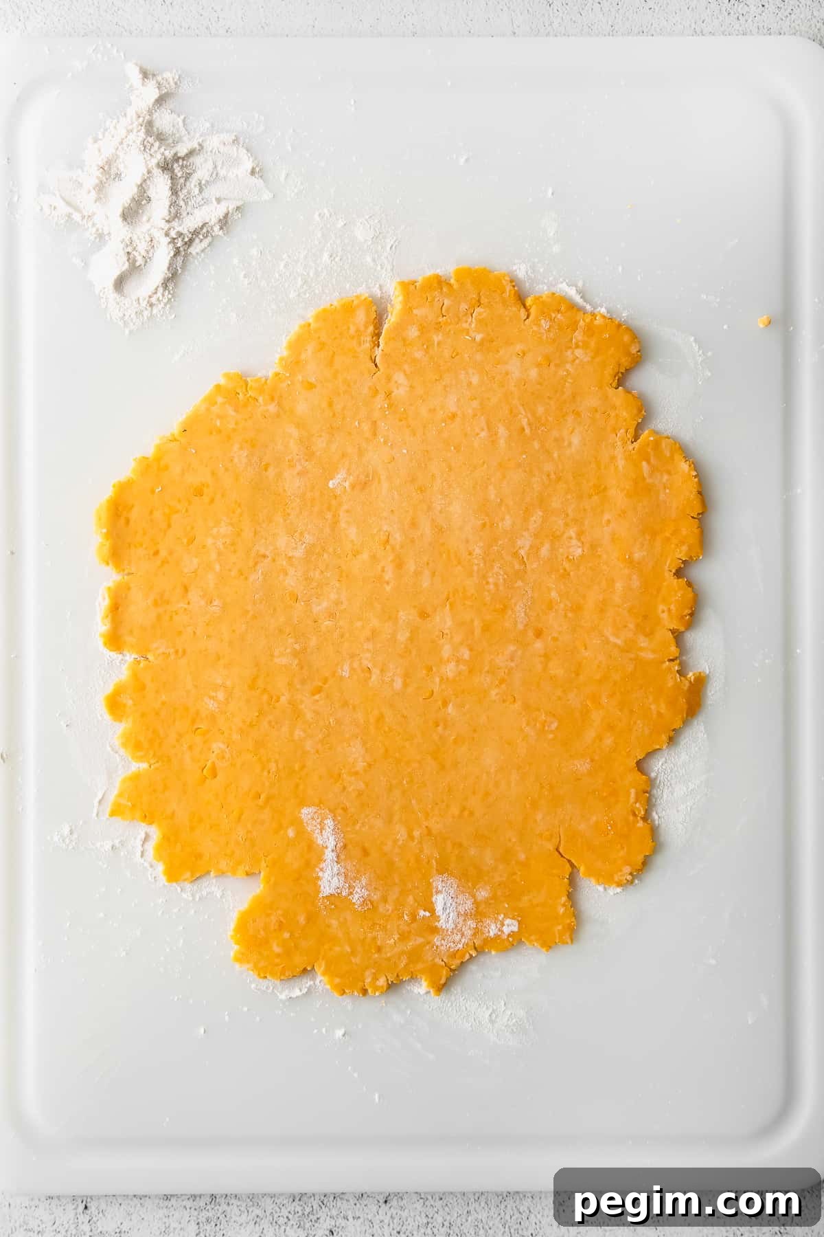 Dough rolled on cutting board.