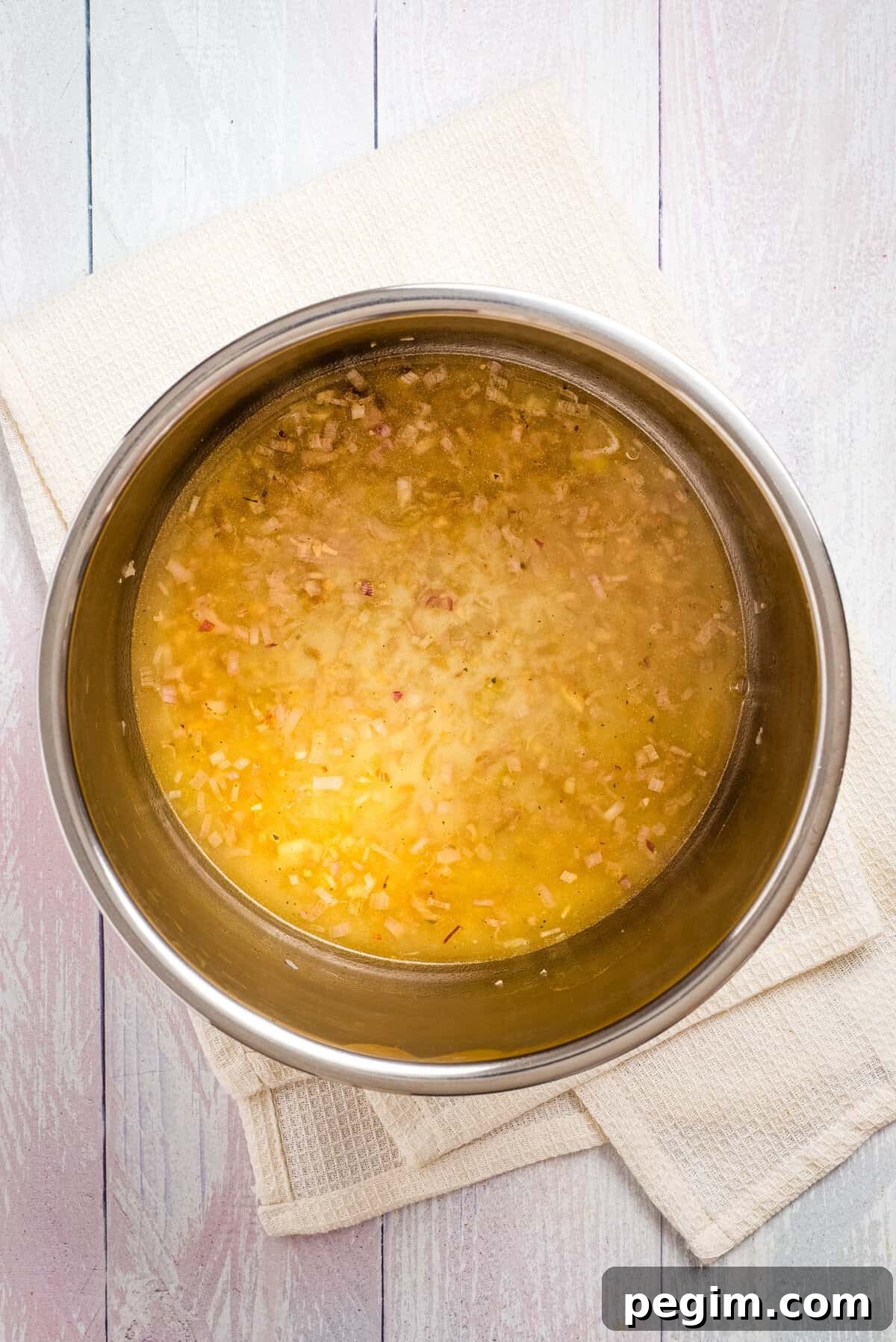 Overhead view of uncooked instant pot tomato soup added with vegetable broth.