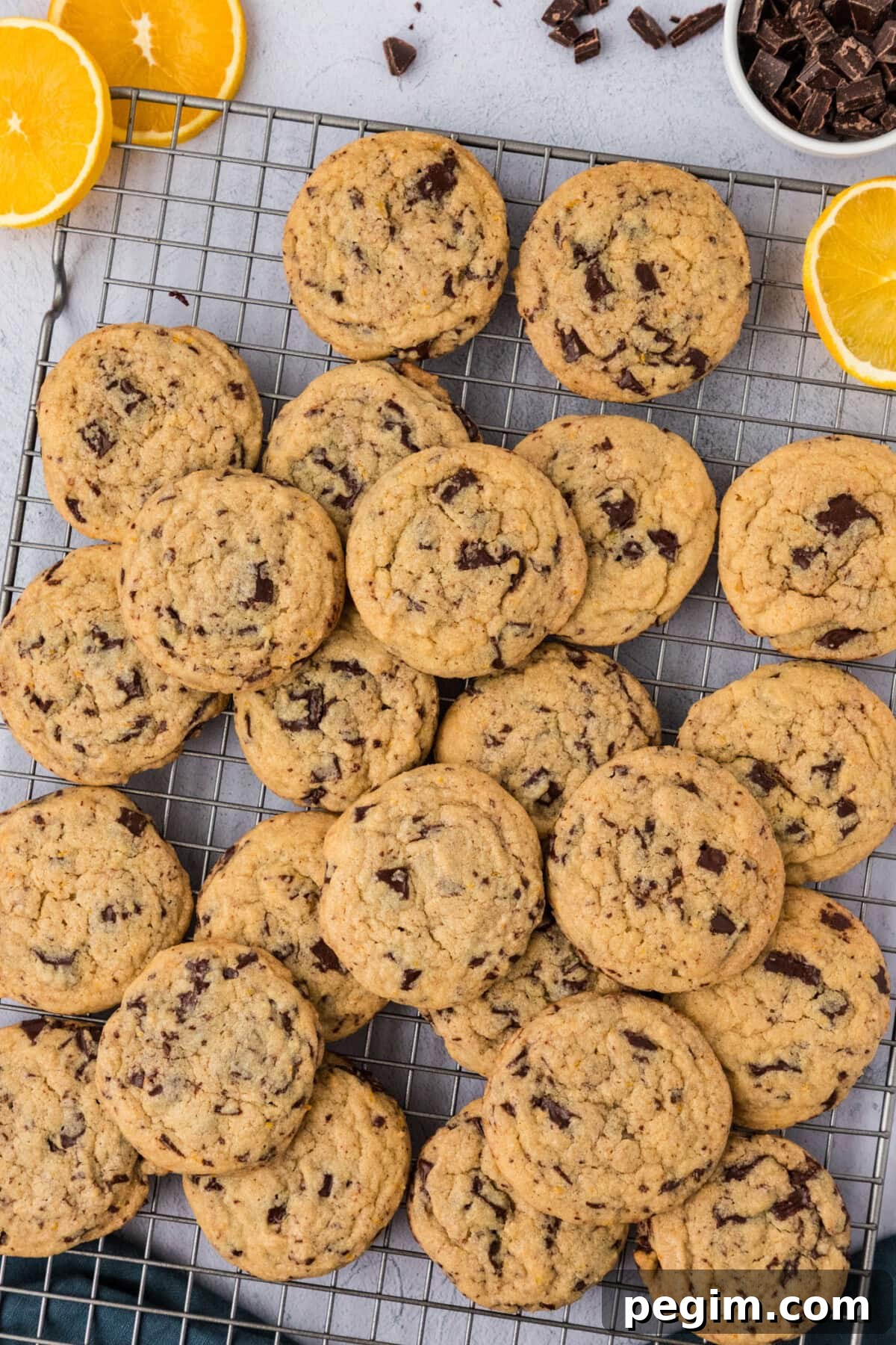 Pile of Orange Chocolate Chip Cookies on a wire rack