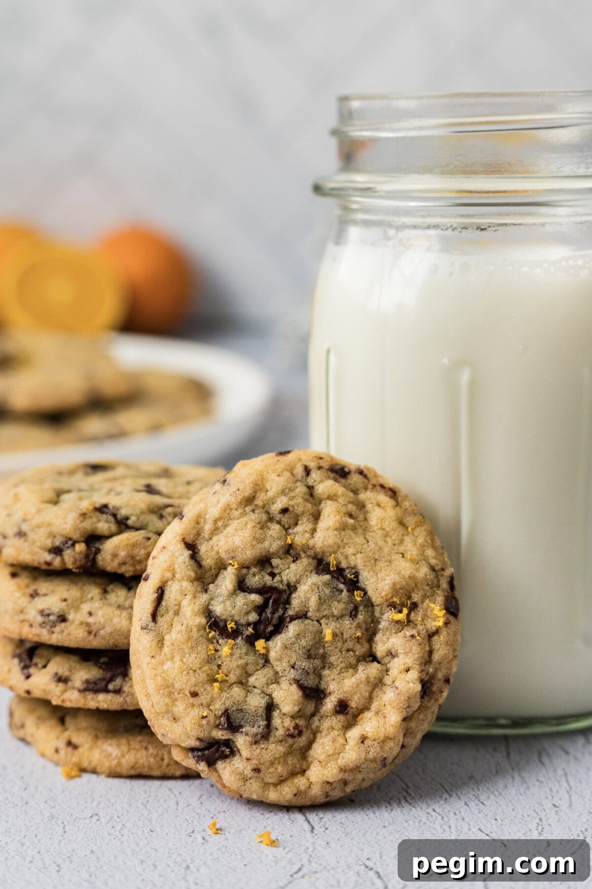 Orange Chocolate Chip Cookies resting against a glass of milk