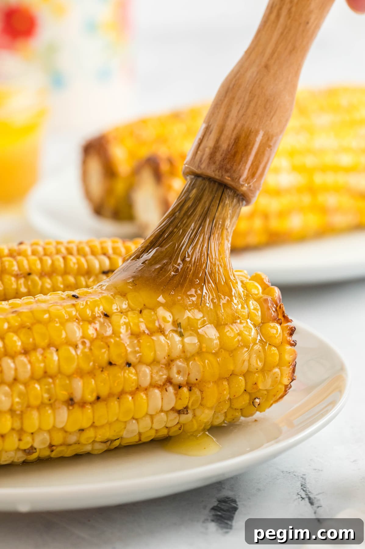 Crispy Air Fryer Corn on the Cob Recipe 9 melted butter brushed on air fryer corn on the cob