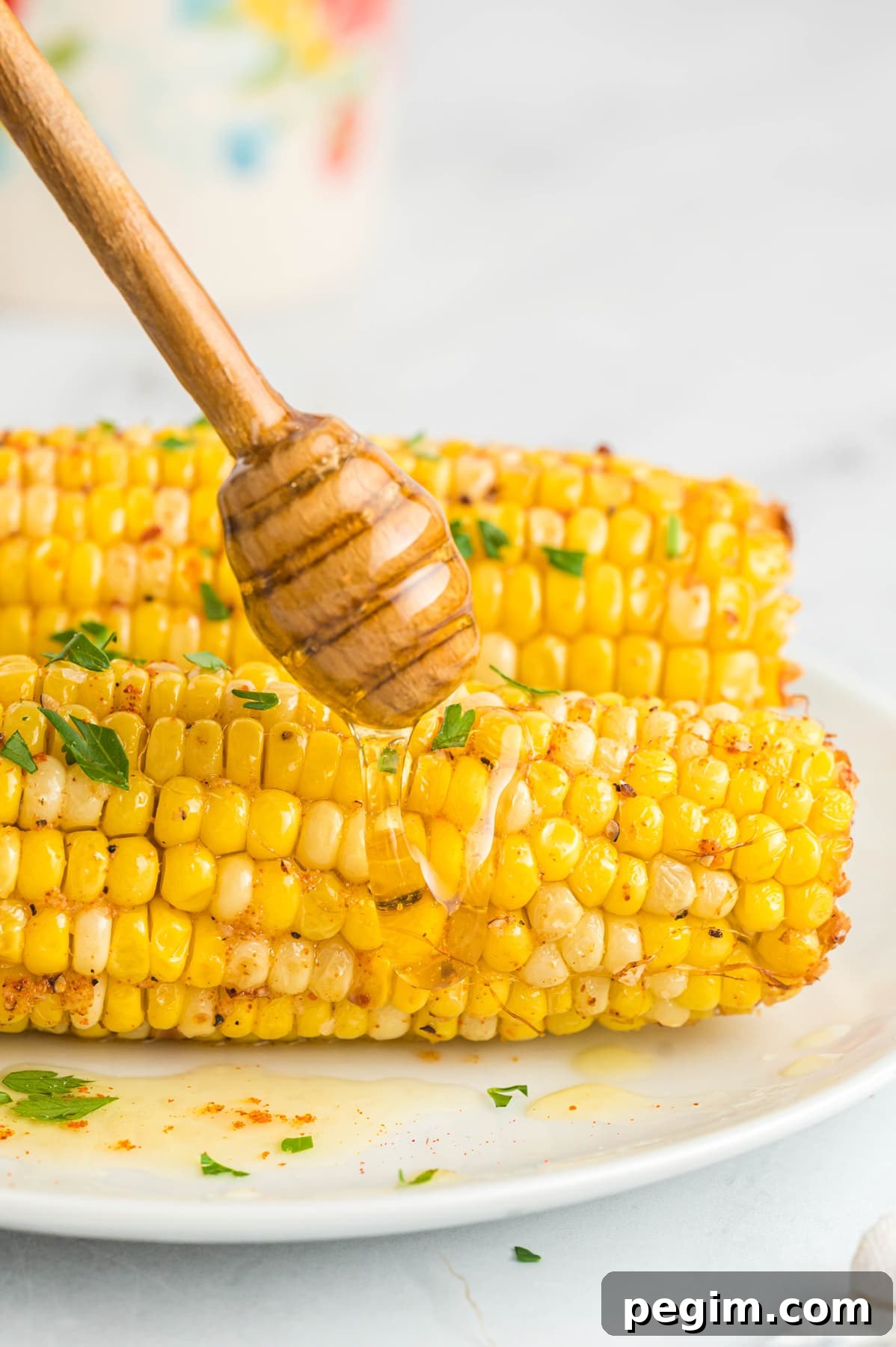 Crispy Air Fryer Corn on the Cob Recipe 10 honey drizzled on air fryer corn on the cob