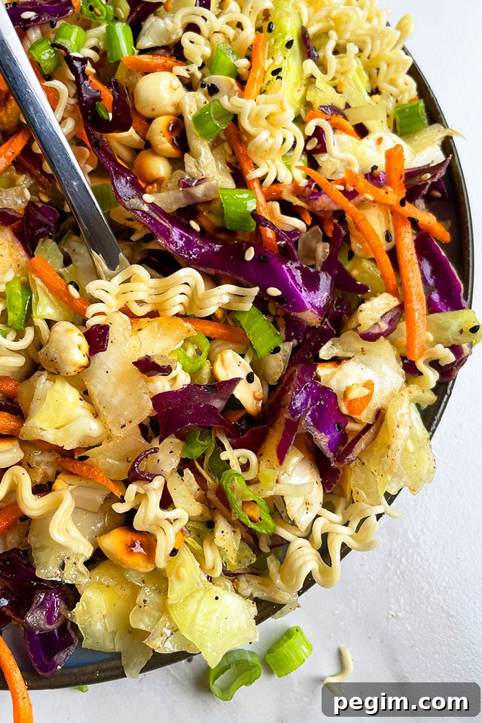 Spoonful of Crunchy Asian Slaw With Ramen on White Background