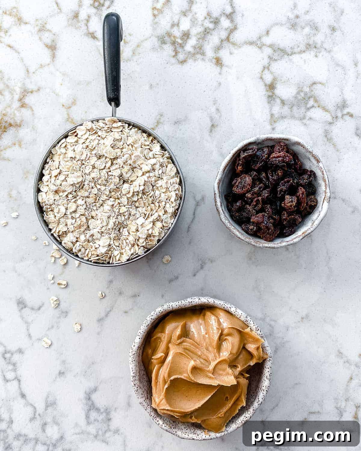 ingredients for Oatmeal Raisin Protein Balls measured out against a white surface