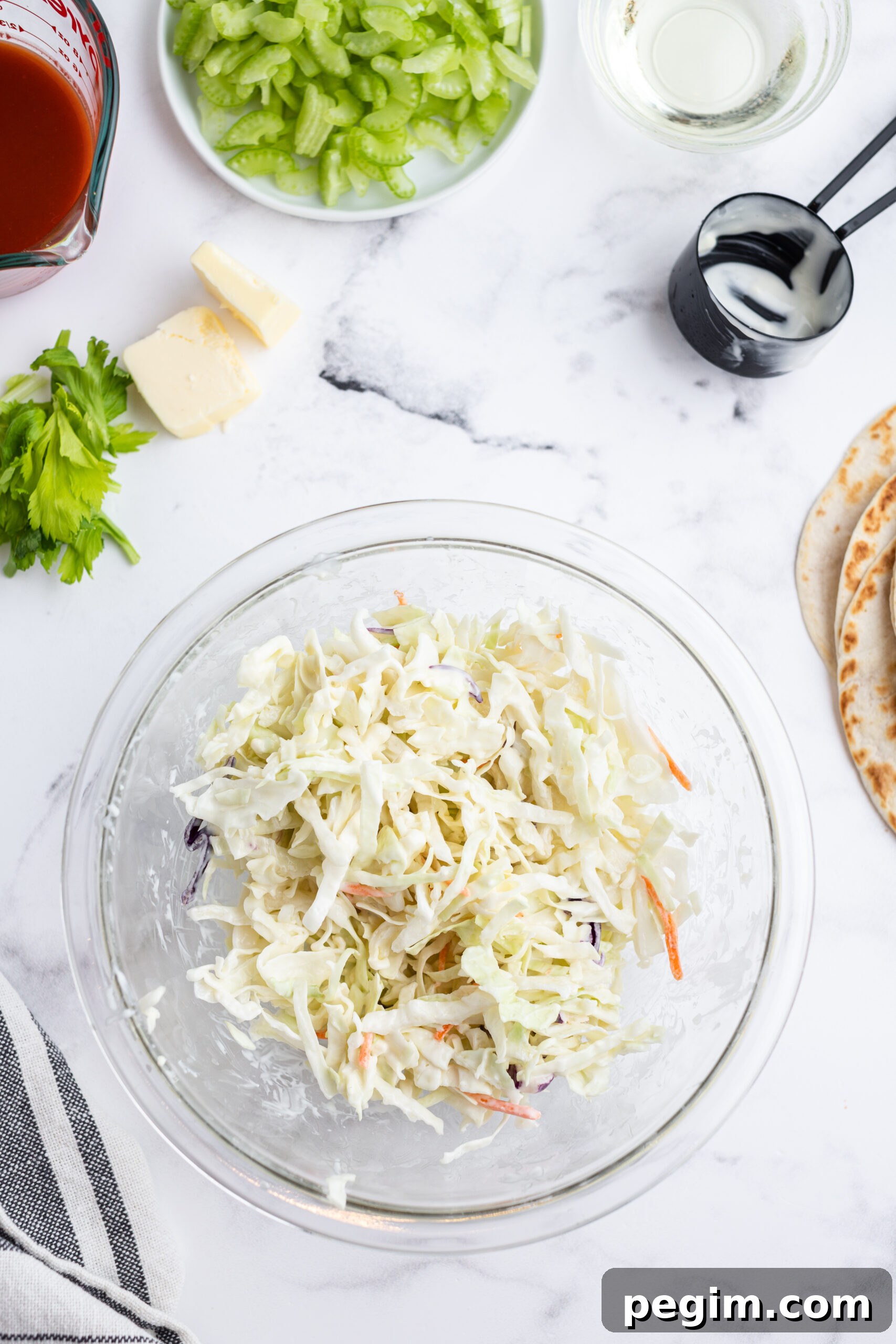 Cabbage slaw in a glass bowl.