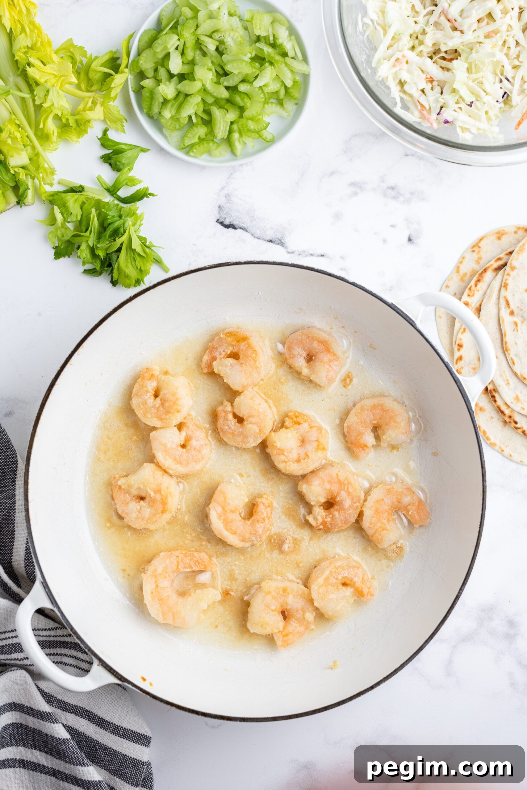 Cooked shrimp in a cast iron skillet.