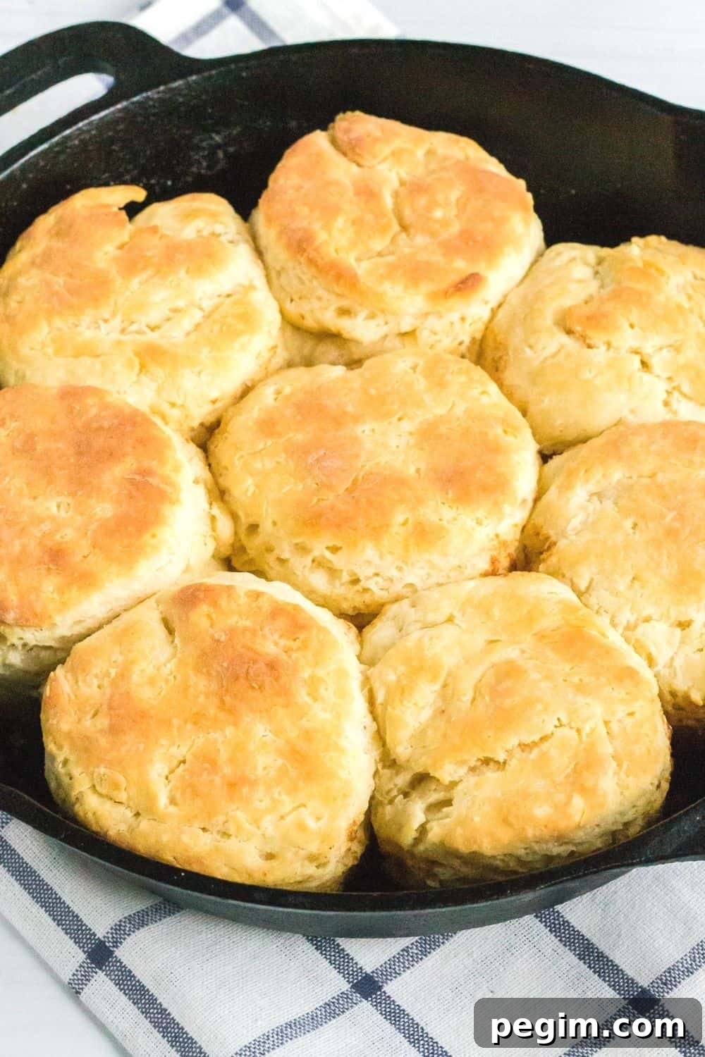 close-up view of golden-brown southern biscuits made with sour cream, freshly baked in a cast iron skillet