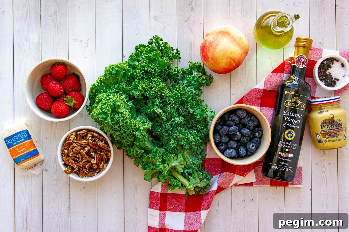 Ingredients for making a summer kale salad with blueberries, goat cheese, peaches, and pecans.