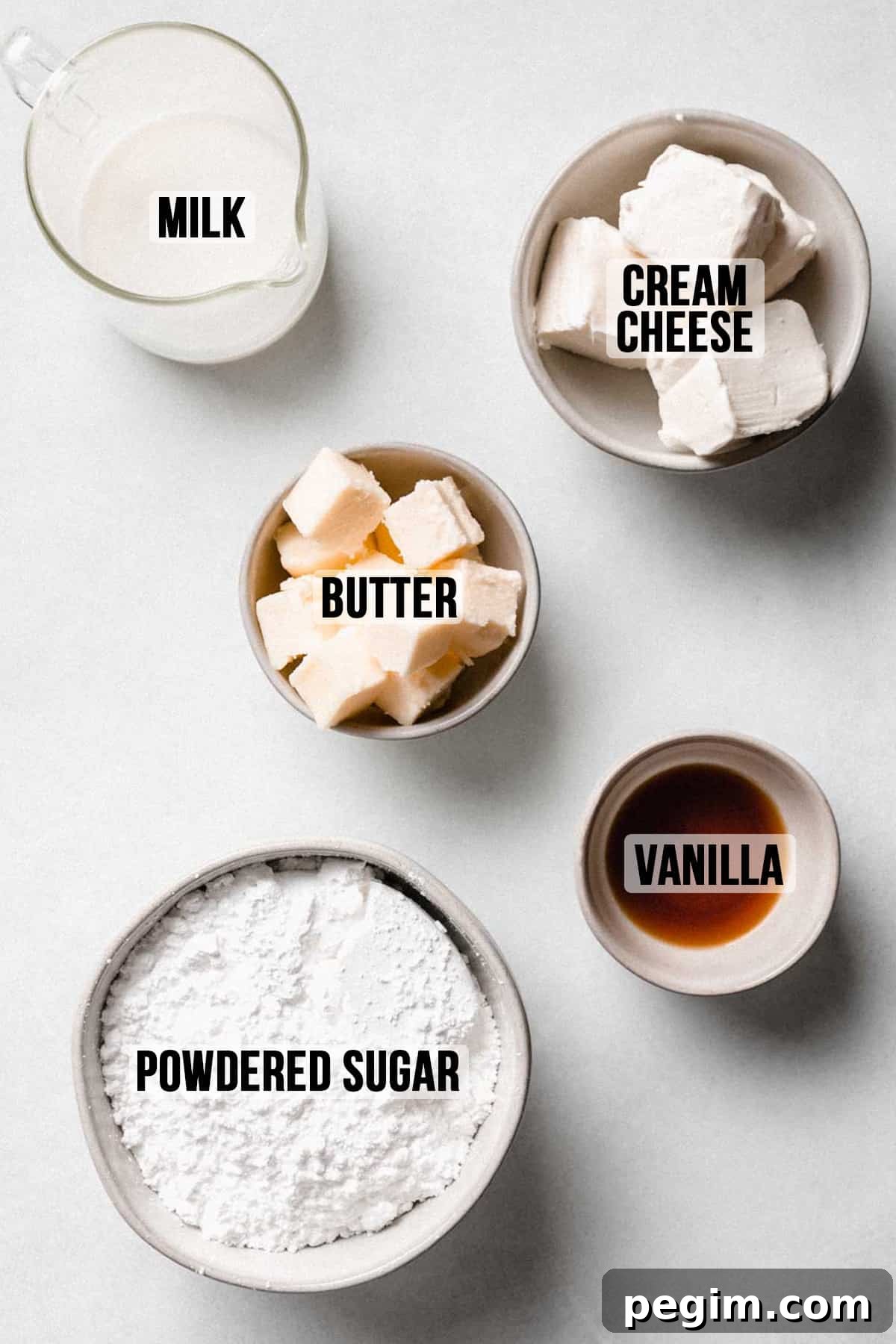 Ingredients for the icing measured out in bowls.