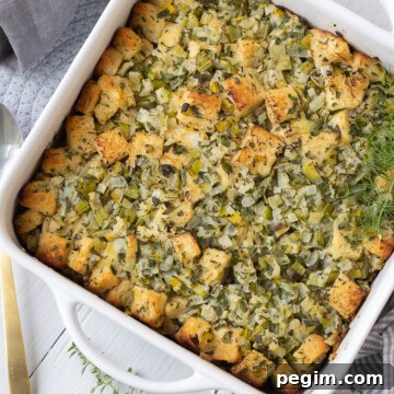 Classic herbed bread stuffing in white casserole ready to serve.