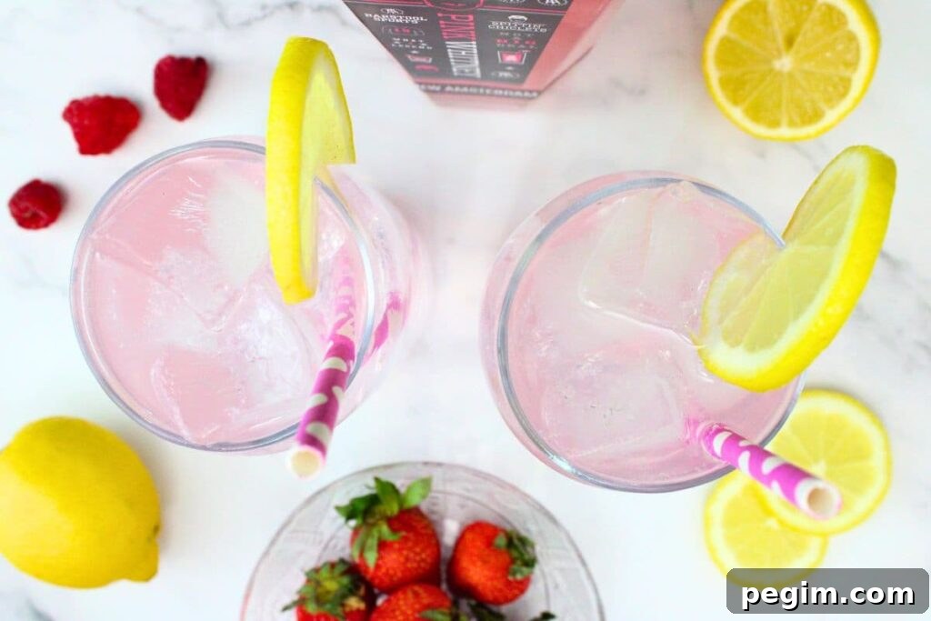 overhead view of pink whitney vodka and sprite with lemon slices