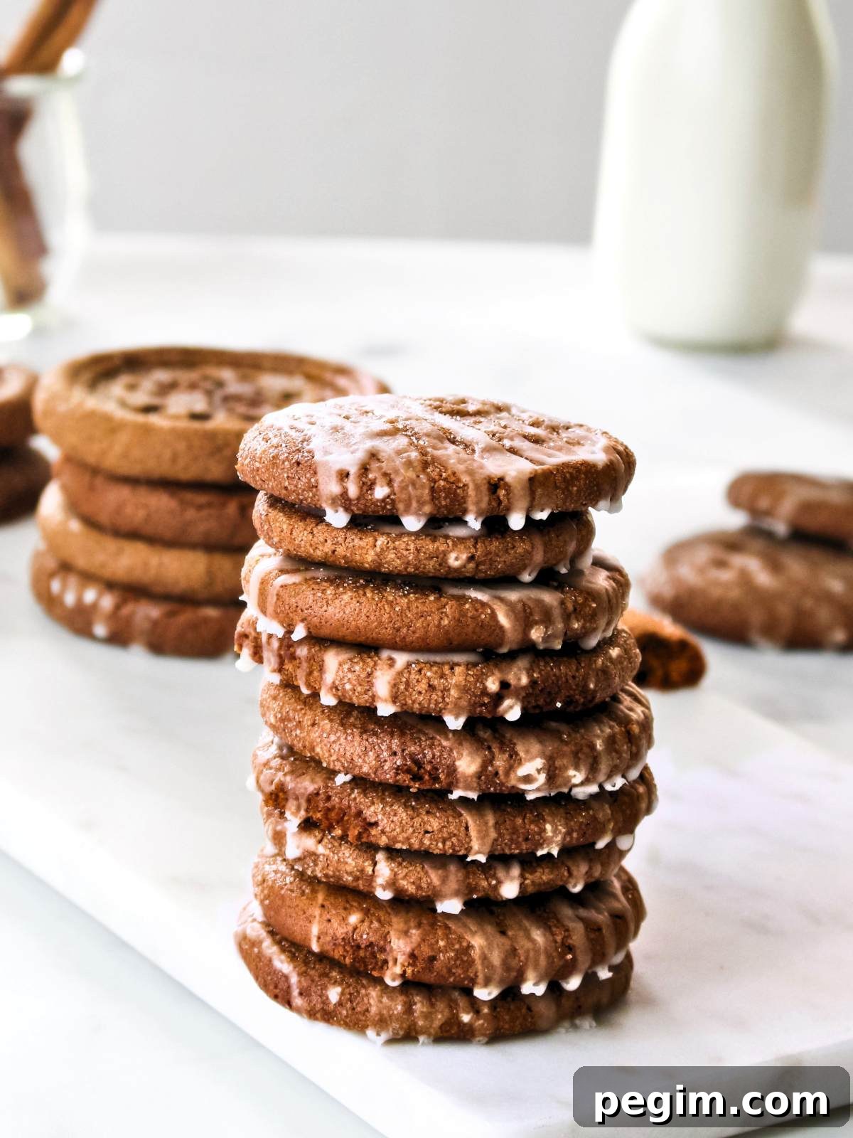 Chewy pumpkin snap cookies stacked up on a table