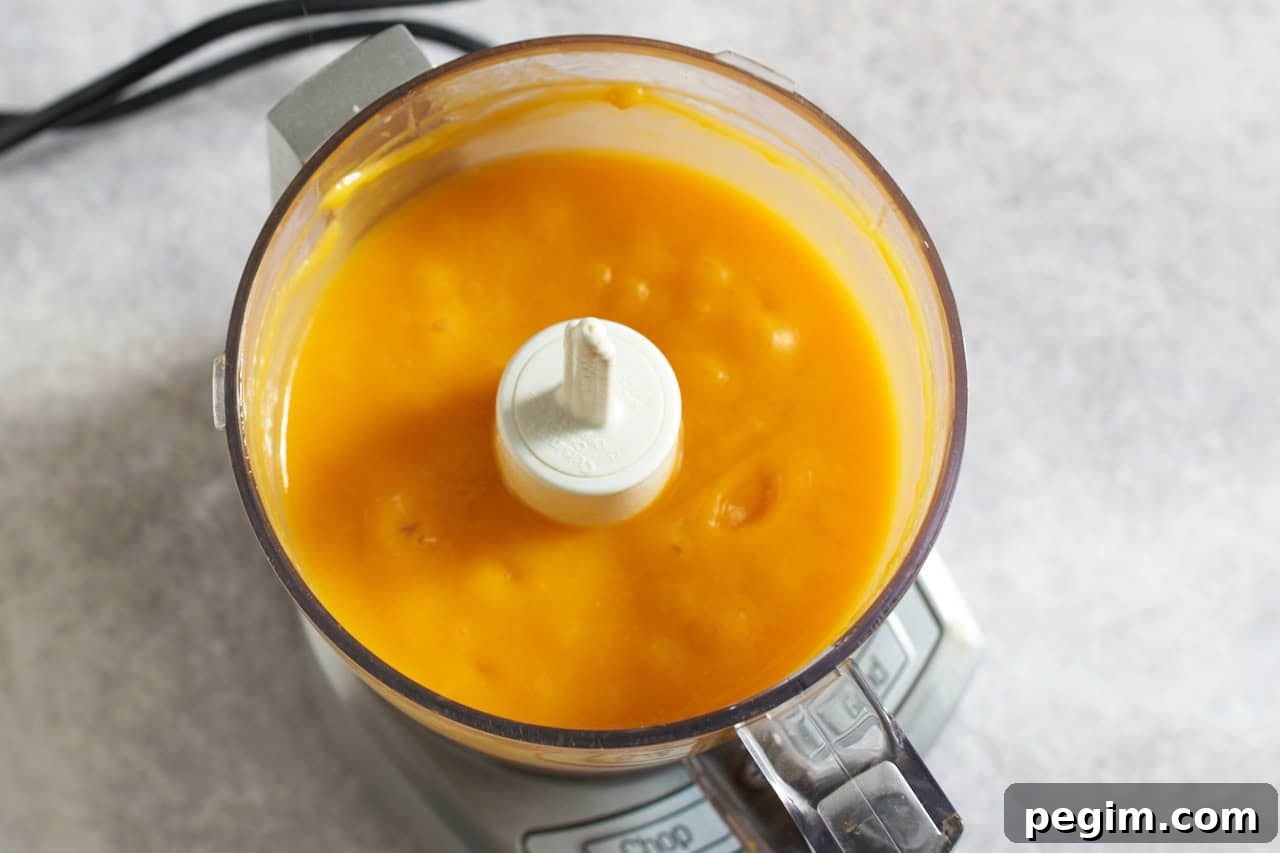 Mango pulp in a food processor.
