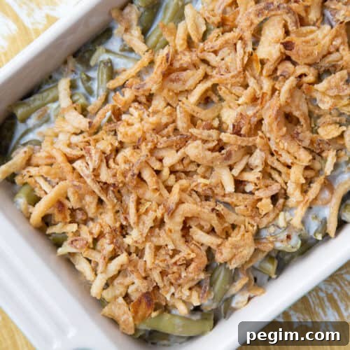 green bean casserole topped with fried onions in a casserole dish.