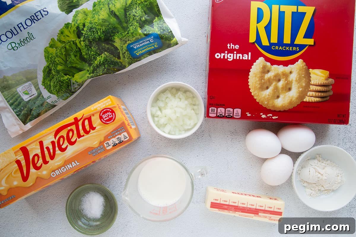 velveeta, ritz crackers, broccoli, and other ingredients on a white table.