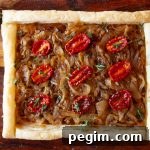 Step-by-step instructions for making a French onion tart with photos. Mushrooms and tomatoes are added for extra umami. This makes a perfect fall supper or party appetizer.