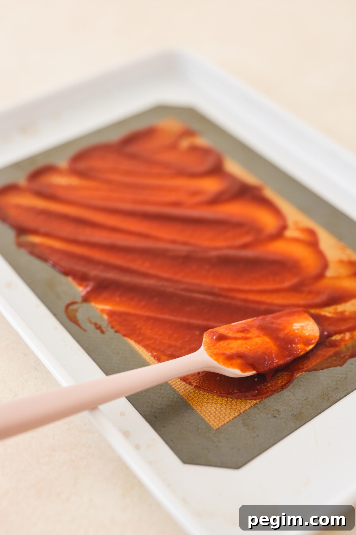 spreading gochujang on a baking mat