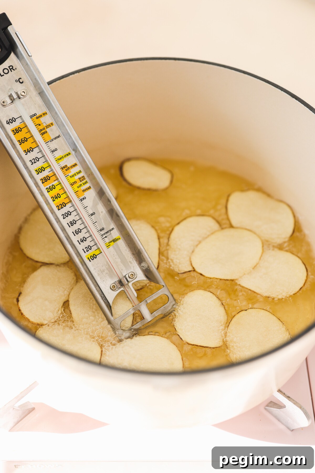 potatoes frying in a pot of oil