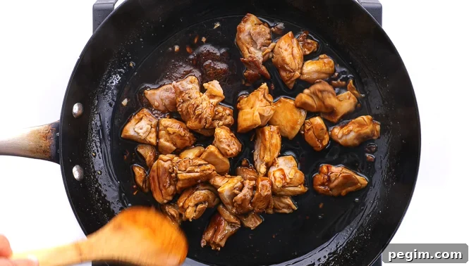 tossing chicken in teriyaki sauce