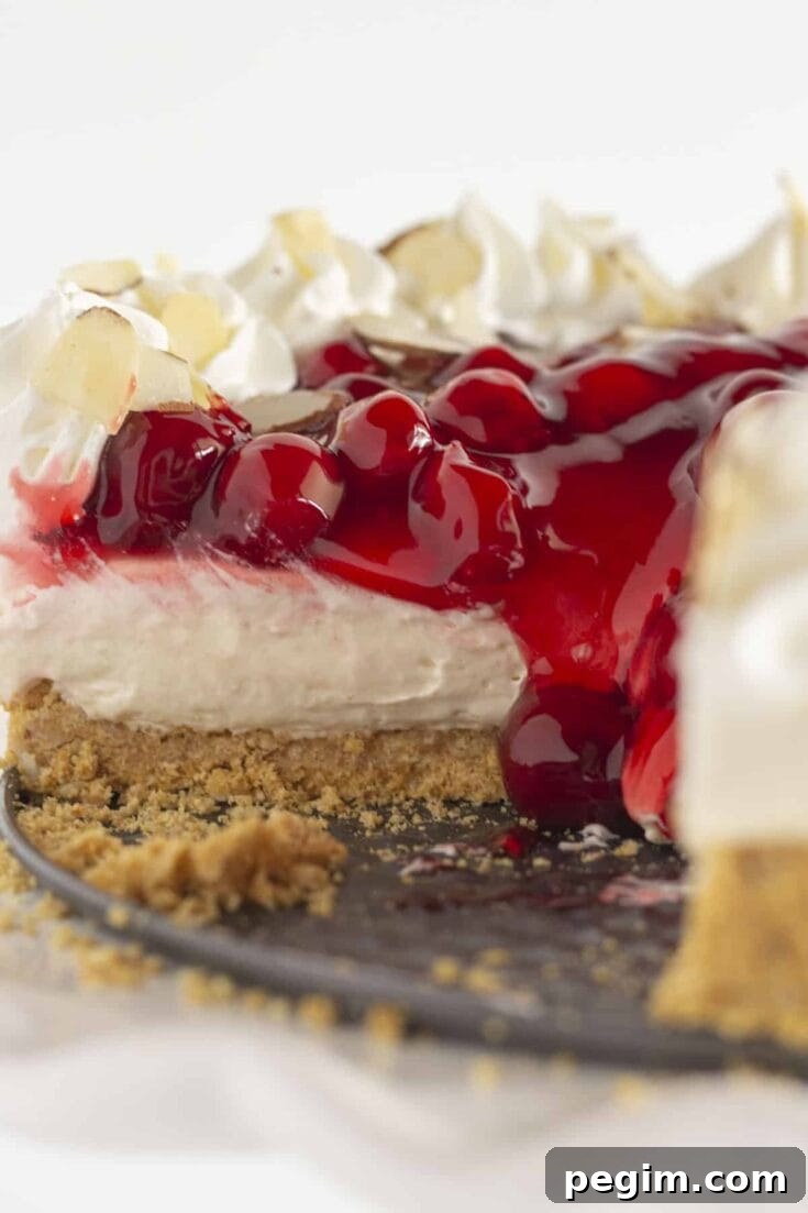 A no bake cherry cheesecake with slices taken out.