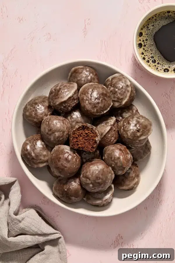 Dairy Free Donut Holes in a serving bowl with coffee to the side.