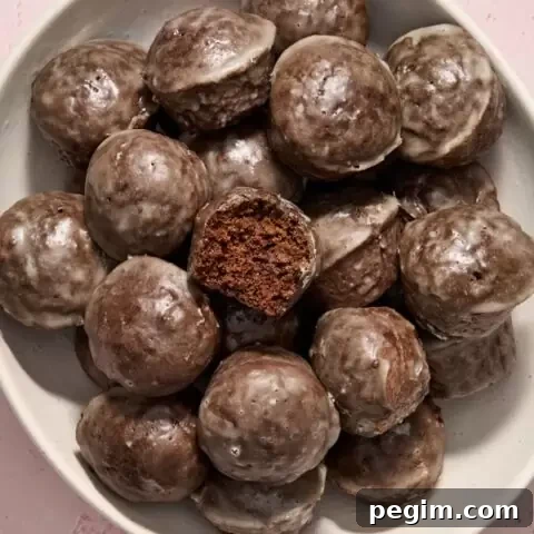 Dairy Free Chocolate Donut Holes piled in a white bowl.