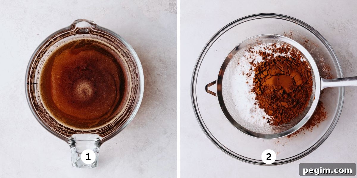 Dissolving espresso powder with warm water in a glass measuring cup and sifting flour and cocoa powder into a glass bowl on a white marbled background.